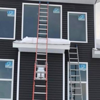 ladders on side of house in preperation for window cleaning clarksville mi